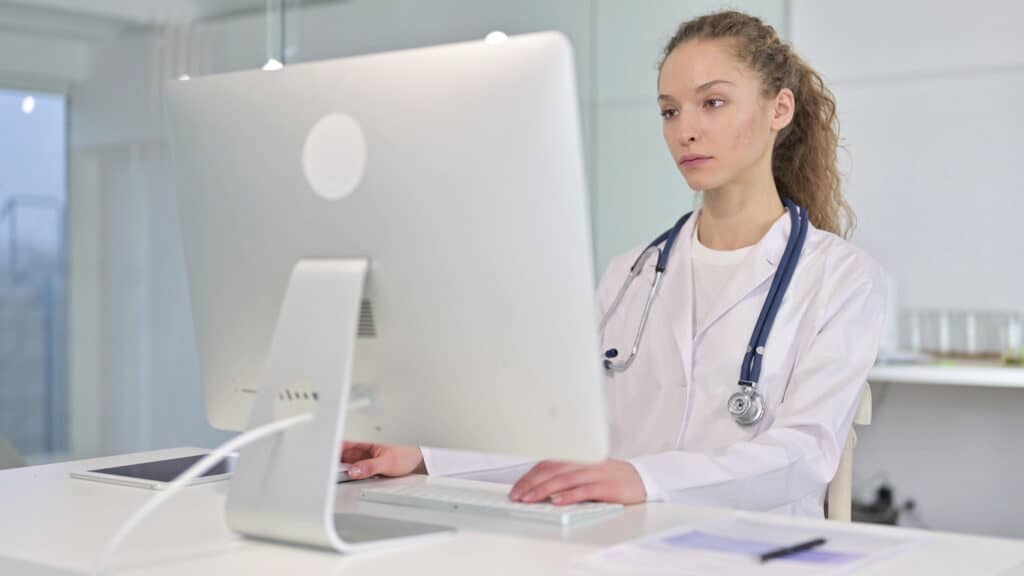 Female doctor browsing through websites for therapists in an office setting